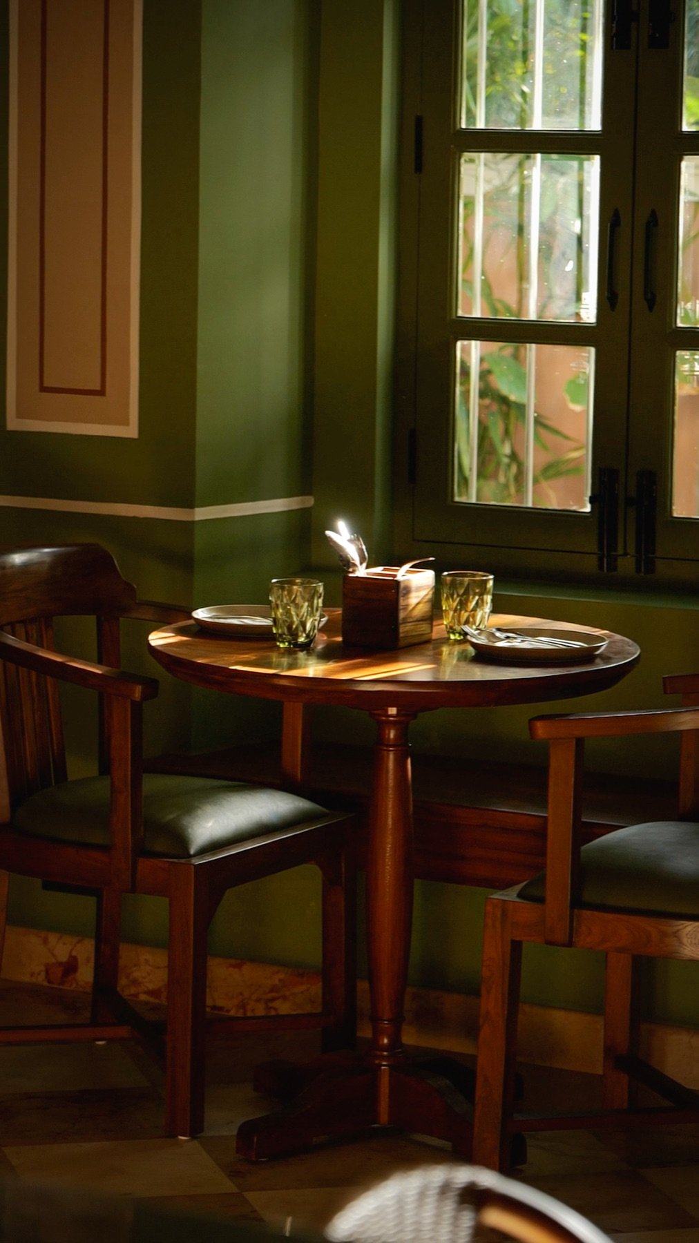 CherryPond heritage garden café interior, White Town Pondicherry — heritage bungalow with blush pink walls and green doors